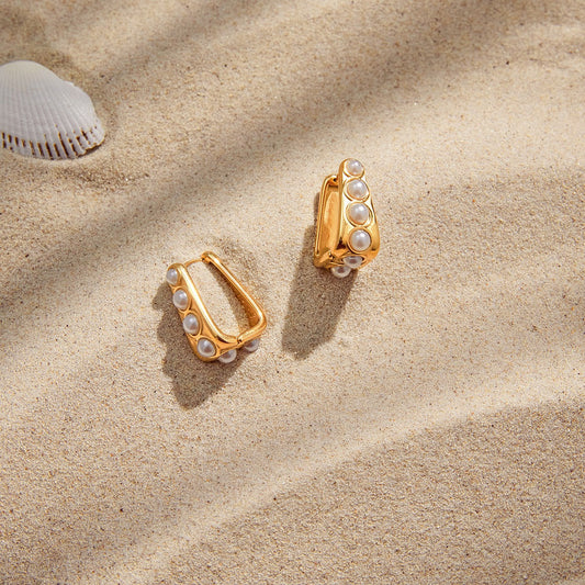 18K gold lightweight luxury earrings with embedded pearls.
