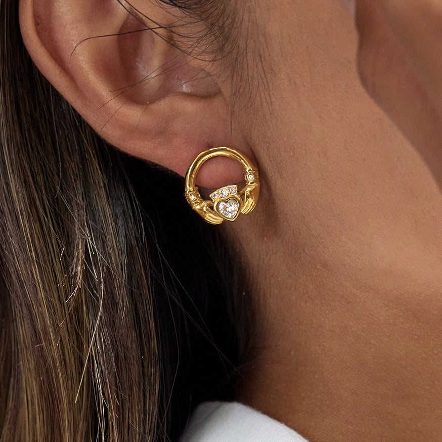 18K gold-plated friendship hand design titanium steel stud earrings with cubic zirconia.